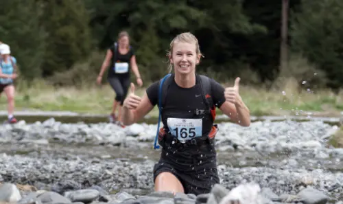 Woman running Loop the lLake race at Lake Rotoiti